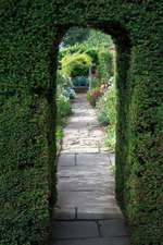 A Flagstone Path Through a Yew Arch Into an English Garden Journal