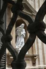 Statue of Saint Teresa of Avila Viewed Through a Wrought Iron Fence Journal